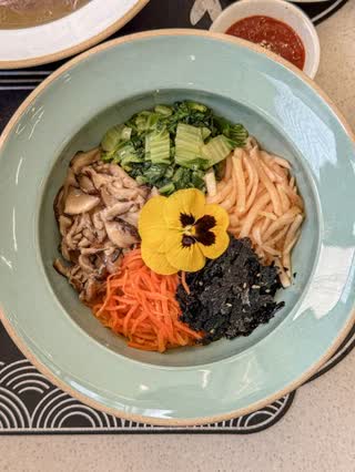 The Daega bibimbap from above, its vegetables and beef arranged by colour